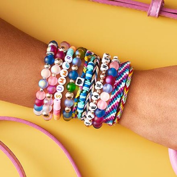 wrist with variety of bead and friendship bracelets